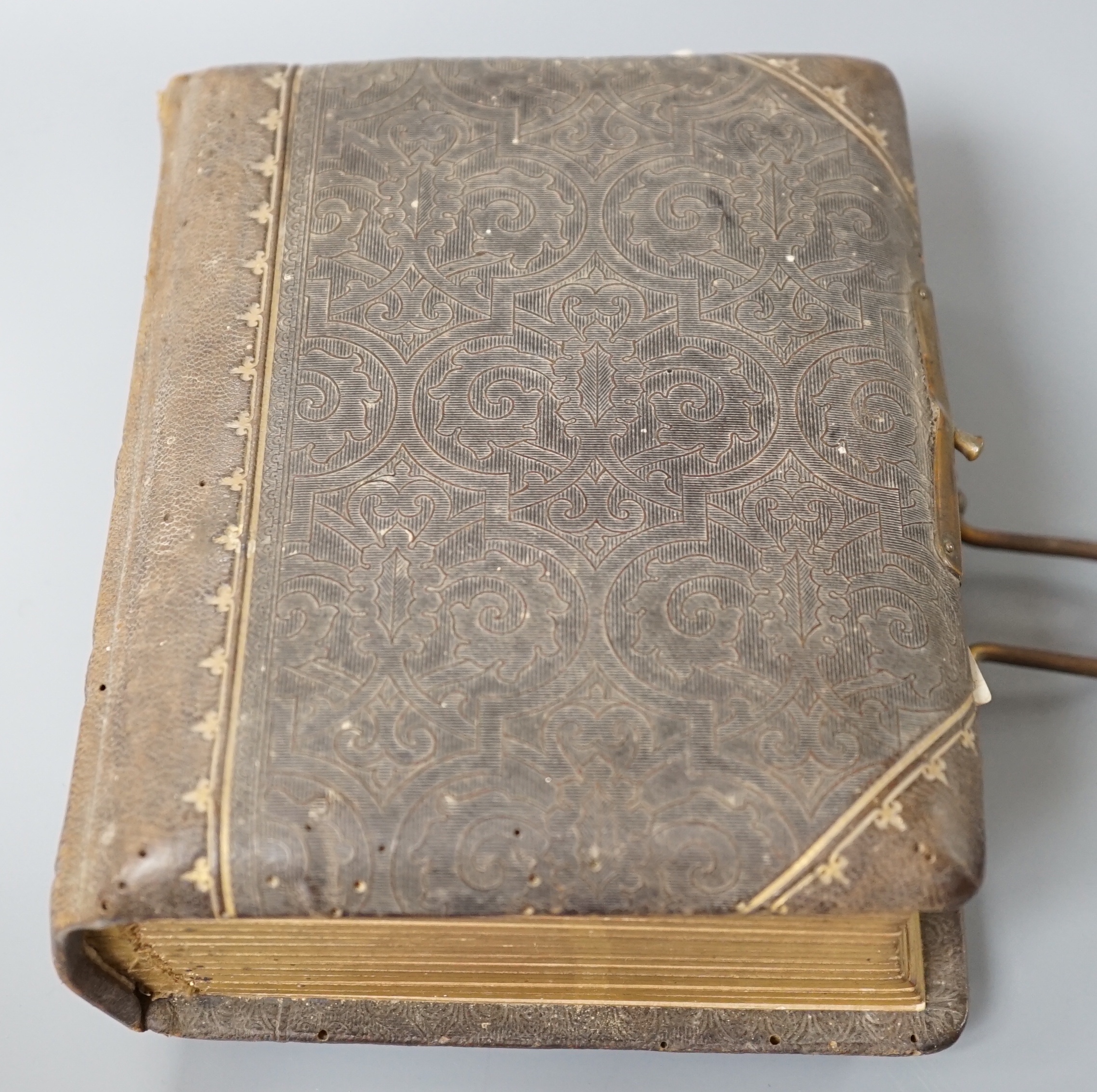 A Victorian portrait photograph album in clasp bound book containing cabinet cards